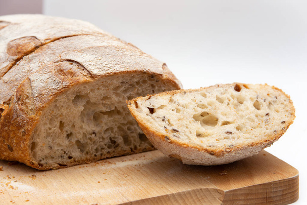 rye bread on a wooden board on a white background. - 写真・画像
