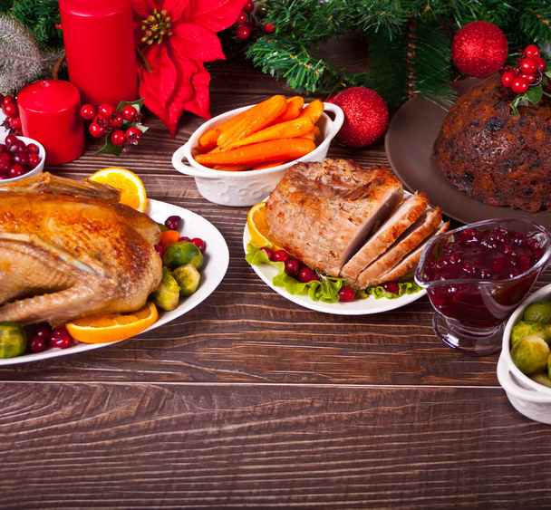 Table served for thanksgiving or Christmas dinner. Stuffed roasted turkey and glazed ham. Traditional celebrating holiday. - Фото, зображення
