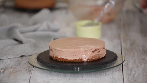 Woman is preparing chocolate cake with cream. Homemade baking. - Footage, Video