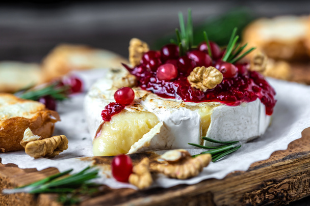 Baked or fried grilled Camembert or brie cheese with berry sauce or jam. Gourmet traditional Breakfast close up. - Photo, Image