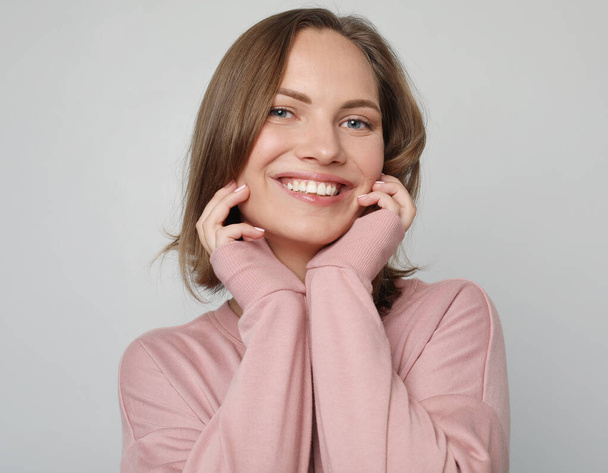 Young smiling blond female wearing pink shirt - Fotoğraf, Görsel