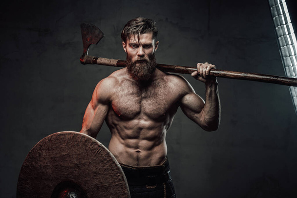 Medieval viking with axe and helmet in dark background - Photo, Image