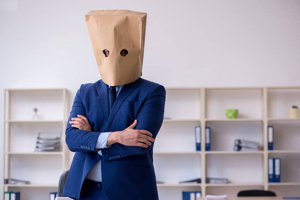 Young male employee with box instead of his head - Photo, Image