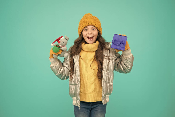 shopping on xmas season. merry christmas. happy new year. Feeling grateful for good gift. fashion kid in trendy puffer jacket. warm winter clothes. online purchase bonus. happy small girl present - Fotografie, Obrázek