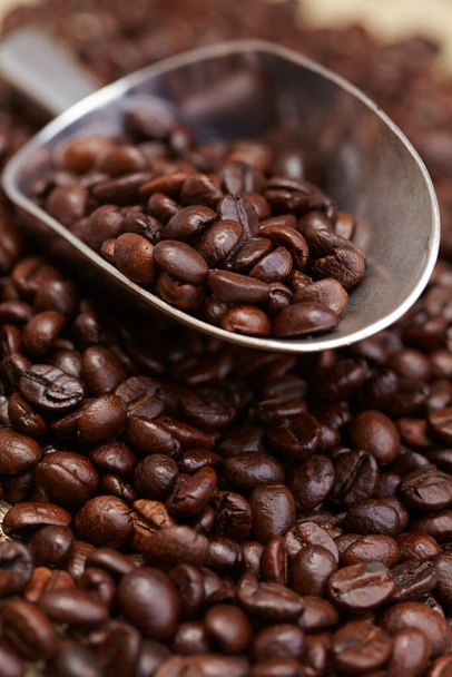 coffee beans in spoon, close view - Fotó, kép