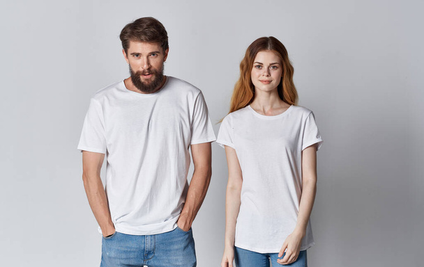 couple in love man and woman in the same t-shirt friends light background - Foto, immagini