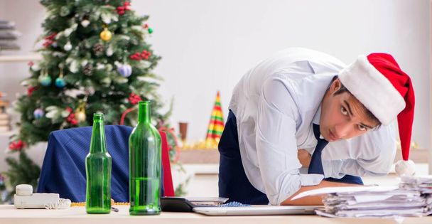 junge hübsche Mitarbeiterin feiert Weihnachten am Arbeitsplatz - Foto, Bild