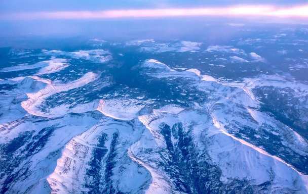 flying over rockies in airplane from salt lake city at sunset - Photo, image
