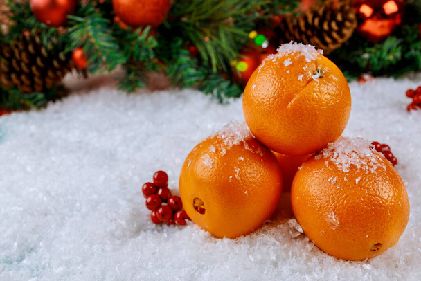 Symbol of Christmas or New Year orange fruit with ornament. Top view. - Foto, Bild