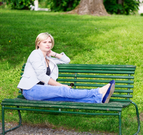 Handsome blond woman on bench - Fotografie, Obrázek