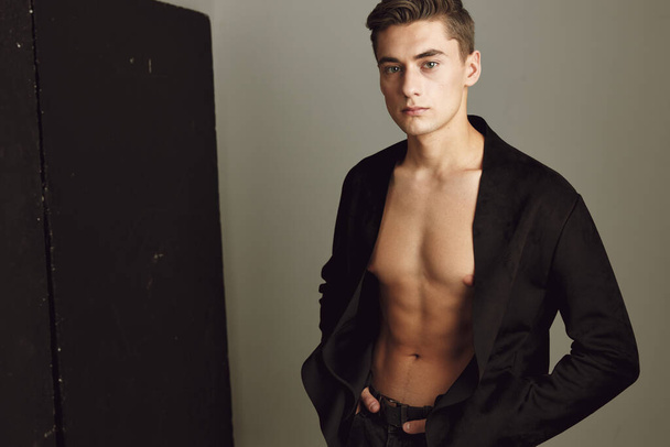Cute young guy unbuttoned black shirt model attractive look - Фото, зображення