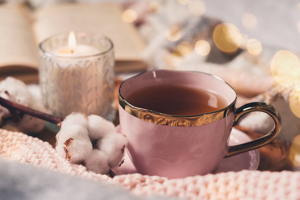Cup of tea, cotton, cozy, book, candle. Cosy autumn winter concept. - Photo, Image