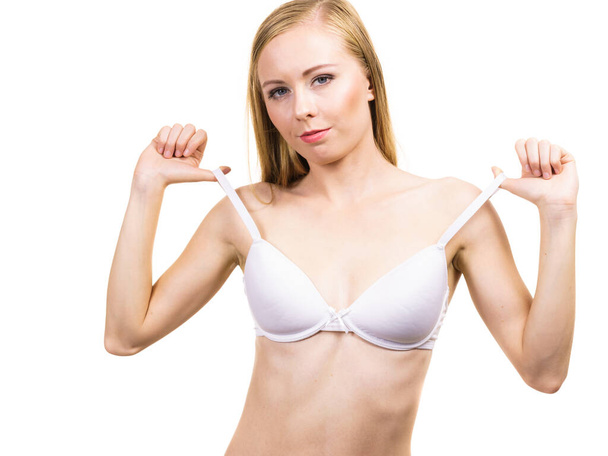 Young slim woman holding bra strap. Straps keep falling down problem. Female breast in lingerie. Bosom and underwear concept. - Φωτογραφία, εικόνα