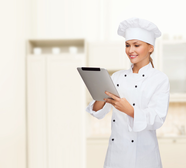Smiling female chef with tablet pc computer - Fotoğraf, Görsel