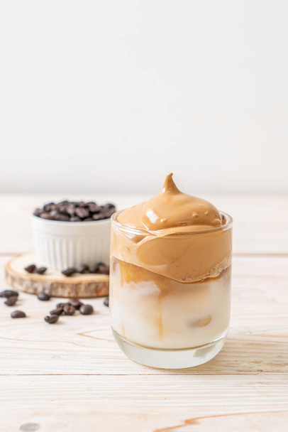 Dalgona coffee. Iced fluffy creamy whipped trend drink with coffee foam and milk. Trendy drink during Covid-19 city lock down and self quarantine, stay at home concept. - 写真・画像