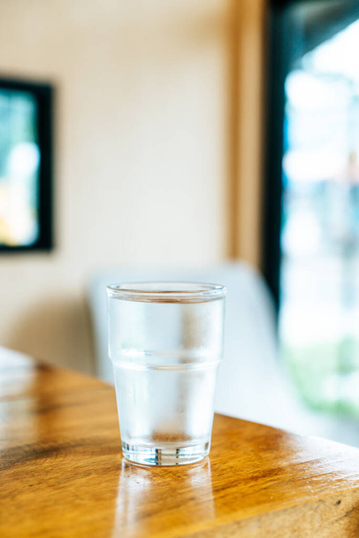 glass of water on wood table - 写真・画像