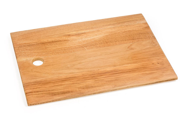 Řezací deska z přírodního lepeného dubového dřeva obdélníkového tvaru s otvorem na bílém pozadí - Fotografie, Obrázek