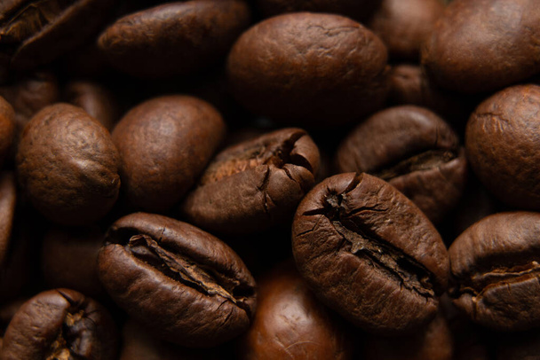 roasted whole coffee beans as background, macro photo - 写真・画像