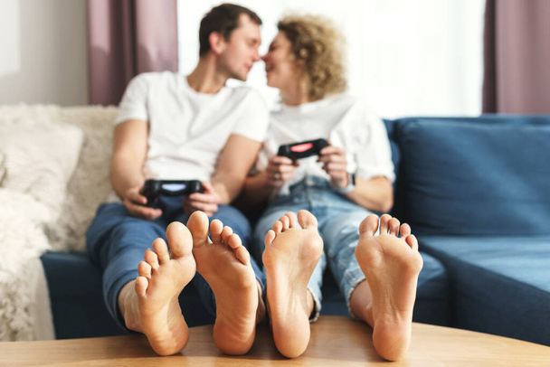 Young happy couple with gamepads are playing video game console - Valokuva, kuva