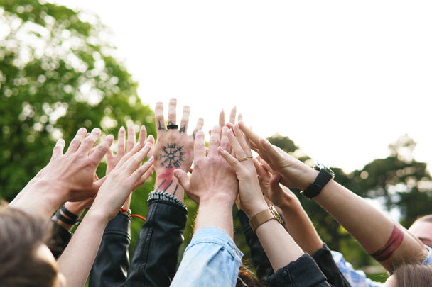 Freedom and friendship. Group of young people putting hands up in the air. - 写真・画像
