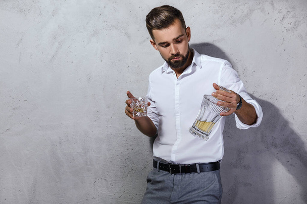 Portrait of Handsome bearded man with a glass of whiskey - Fotoğraf, Görsel