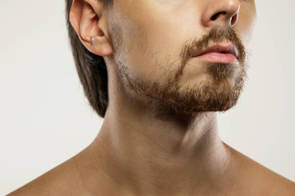 Closeup of unshaved men's face with a unkempt beard - Valokuva, kuva