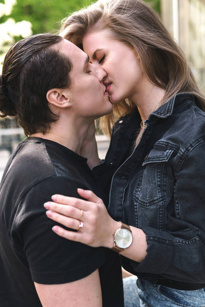 Young and sensual couple in embrace during a date outdoors - Photo, Image