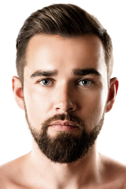 Portrait of handsome bearded man with a smooth skin on white background - Zdjęcie, obraz