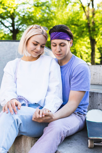 Portrait of sensual and loving teenager couple in a skatepark - Photo, image