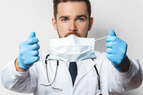 Young doctor is wearing prevention mask against virus spreading - Valokuva, kuva