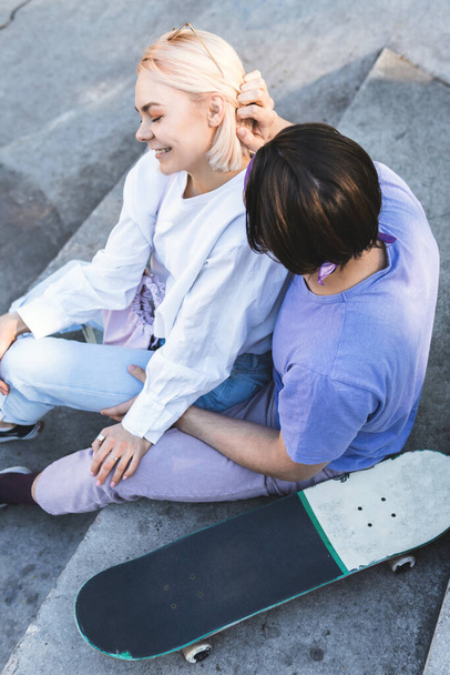 Portrait of happy and loving teenage couple in a skatepark - Foto, imagen