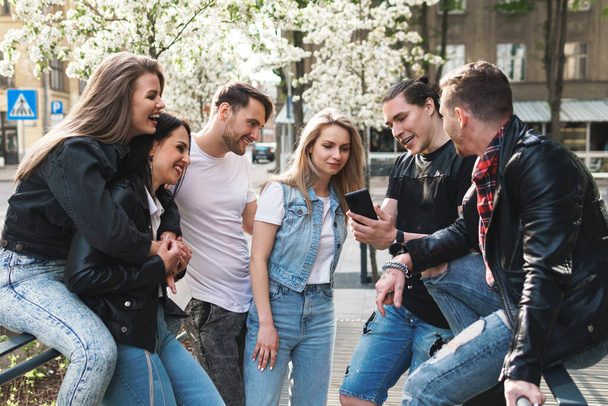 Group of best friends are having fun on a street. Young people happy to see each other during a meeting. - Φωτογραφία, εικόνα