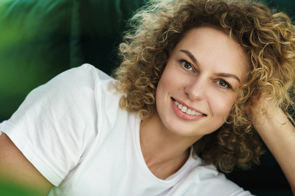 Portrait of young beautiful woman with a curly hair and smooth skin - Fotoğraf, Görsel
