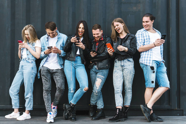 Group of young and stylish people using smartphones instead of real communication - Photo, Image