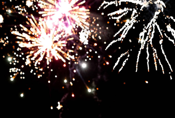 Colorful blurry fireworks in the night sky. Background for the design - Photo, image