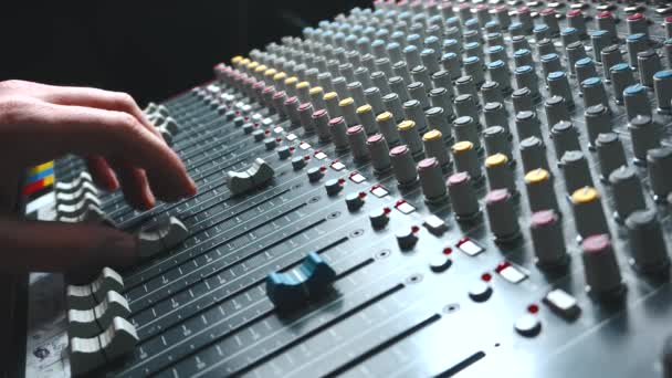 Footage of sound engineer making adjustment on mixer, soundboard - Filmati, video