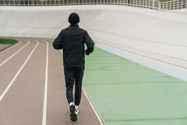 Sportovní sportovec běží při cvičení na stadionu venku - Fotografie, Obrázek