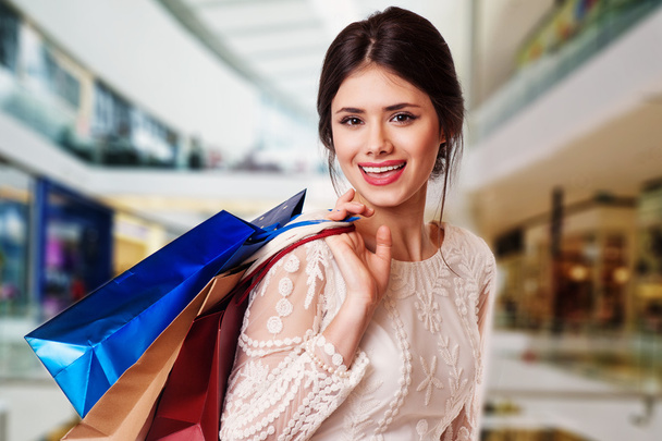 Beauty Woman with Shopping Bags in Shopping Mall. - 写真・画像
