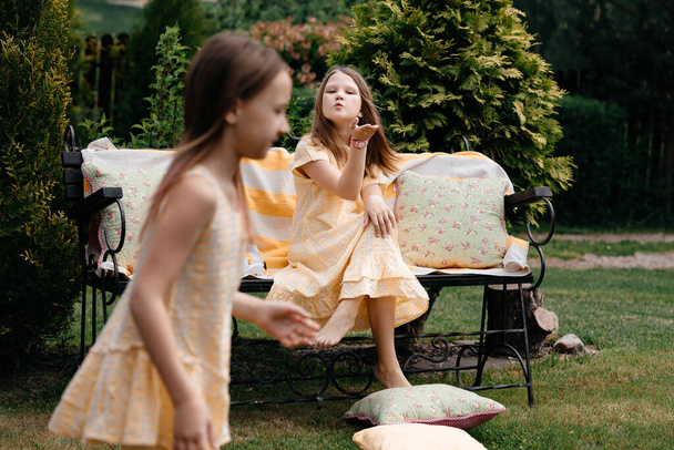 Small children play games in the summer at the dacha. Summer holidays. The concept of children's style and fashion. Toning. - Photo, Image