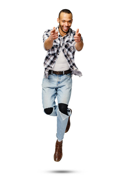 Casual african-american man jumping in studio over white background - Fotoğraf, Görsel