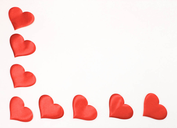 Cadre d'angle de cœurs en satin sur fond blanc. Le concept de Saint-Valentin. - Photo, image