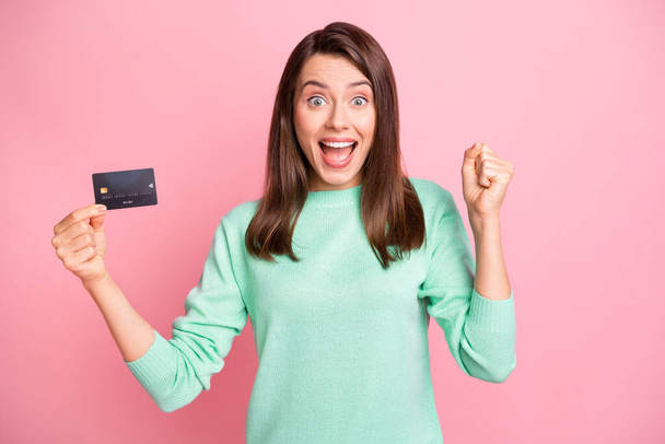 Portrait of hooray nice brunette young woman stand promote credit card yell isolated on pink color background - Zdjęcie, obraz