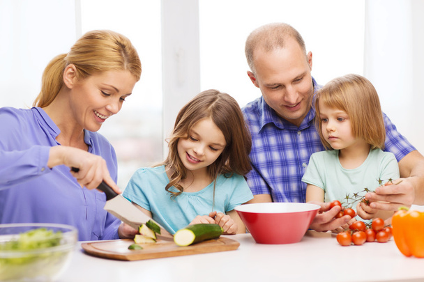 Happy family with two kids making dinner at home - Φωτογραφία, εικόνα