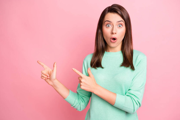 Photo of cute shocked girl indicate forefinger empty space wear teal pullover isolated pink color background - Foto, Bild
