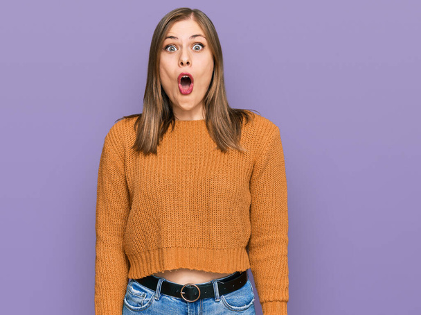 Beautiful caucasian woman wearing casual clothes afraid and shocked with surprise expression, fear and excited face.  - Photo, Image