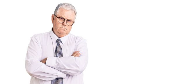 Senior grey-haired man wearing business clothes skeptic and nervous, disapproving expression on face with crossed arms. negative person.  - Photo, Image