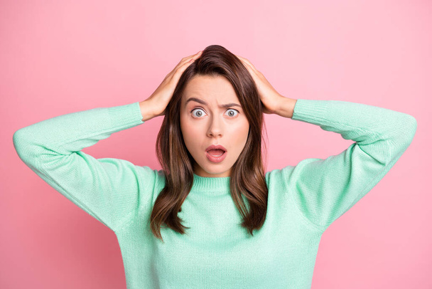 Photo of terrified young lady stare arms on head open mouth teal pullover isolated on pastel pink color background - Φωτογραφία, εικόνα