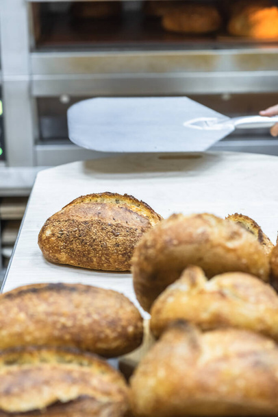 Tartin bread on the table. Making craft bread at the bakery - Φωτογραφία, εικόνα