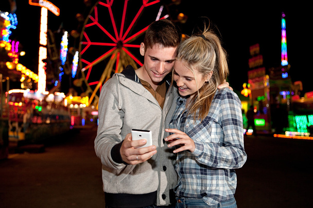 Couple using a smartphone - Фото, зображення
