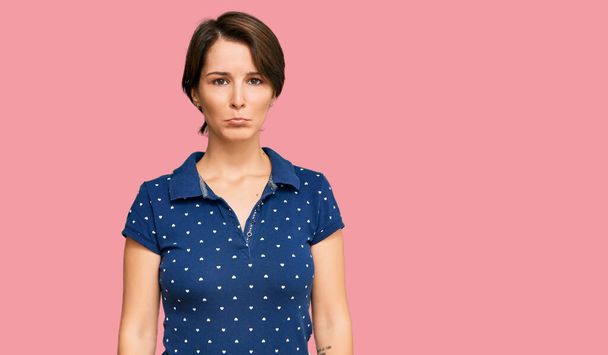 Young brunette woman with short hair wearing casual clothes depressed and worry for distress, crying angry and afraid. sad expression.  - Foto, Imagen